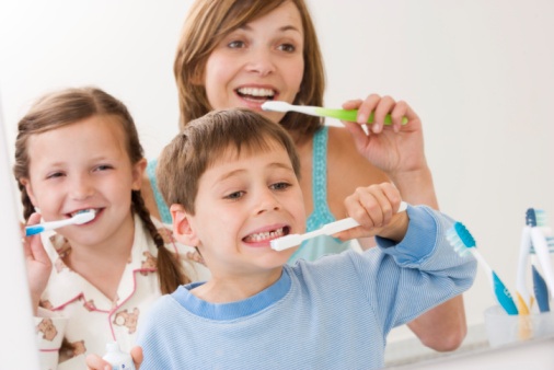 Mother and children brushing teeth