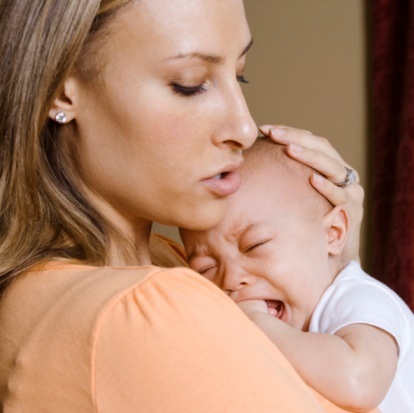 Mother holding crying son