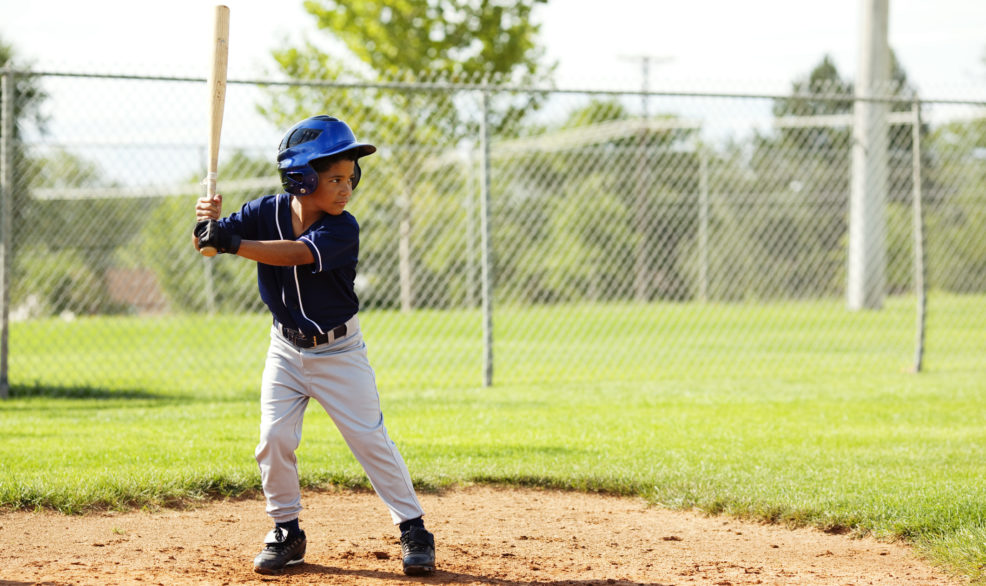 boy at plate getting ready to hit ball