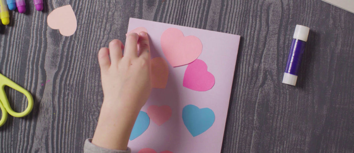 Girl's hands glueing a card