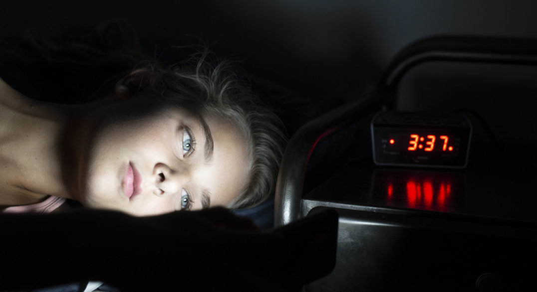 Girl using her smartphone late at night