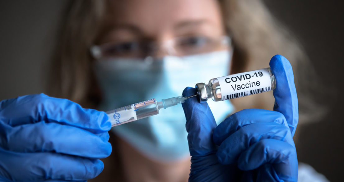 COVID-19 vaccine in researcher hands, female doctor holds syringe and bottle with vaccine for coronavirus cure. Concept of corona virus treatment, injection, shot and clinical trial during pandemic.