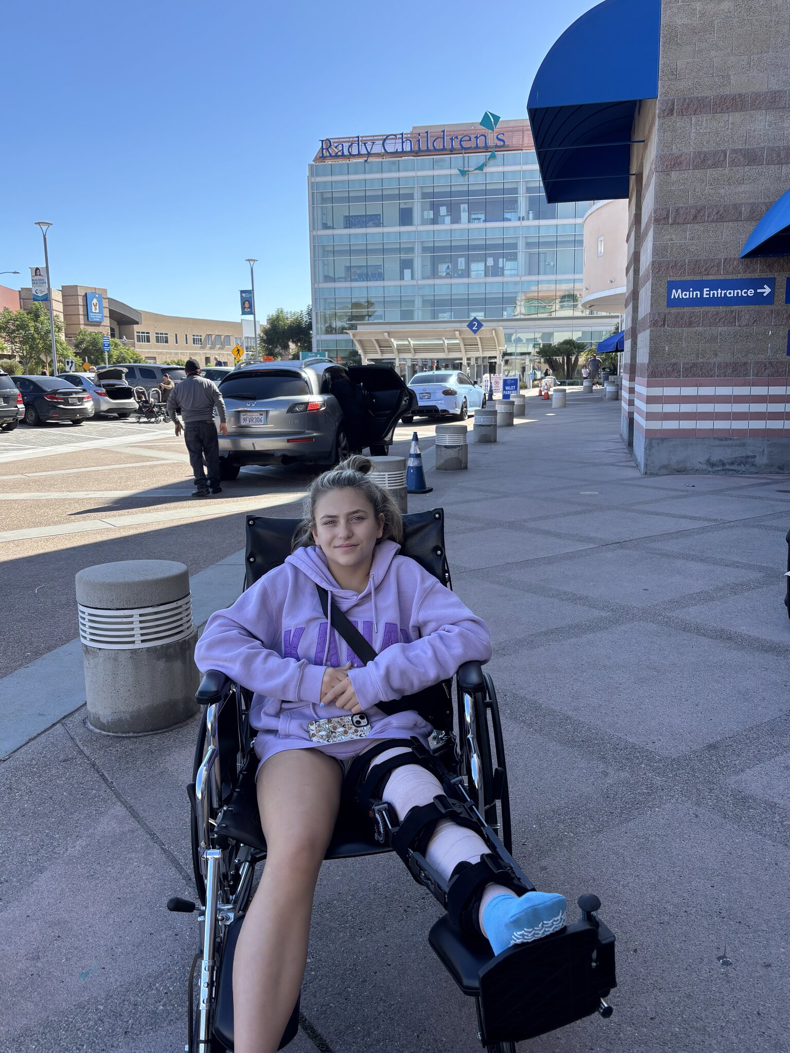 Kaitlin leaving Rady Children's Hospital in a wheelchair after knee surgery